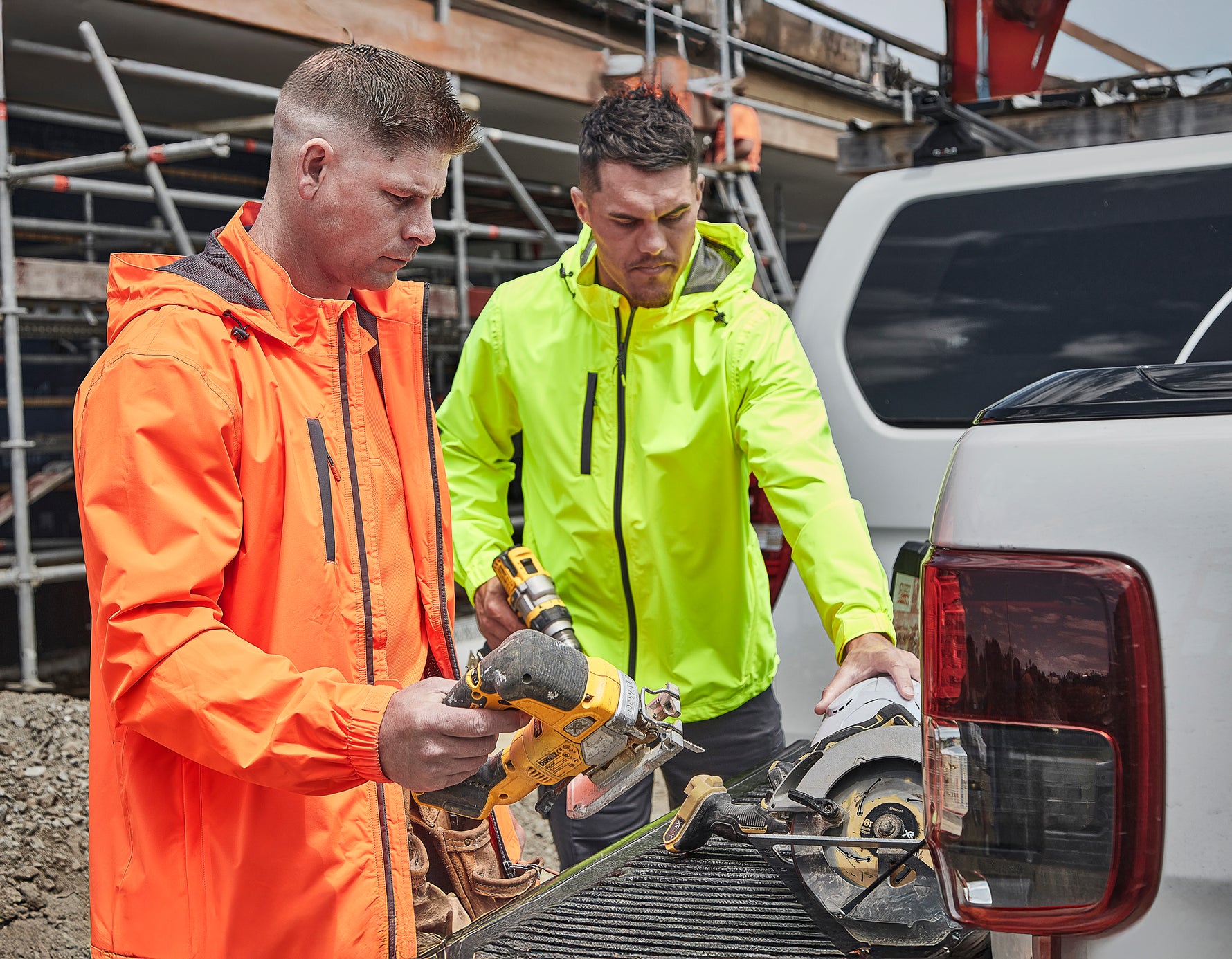 Tradies wearing high-vis jackets from Dori Apparel on-site